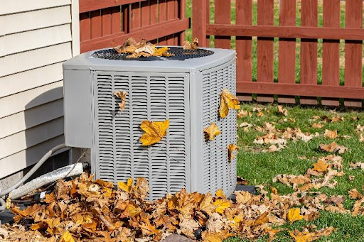 An outdoor air conditioner next to a residential home that requires proper maintenance from a skilled AC specialist in Newark, OH.